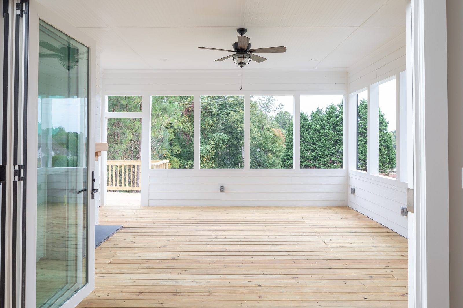 Screened porch looking out to the tree line — Shadburn Ferry, custom home built by Ironwood Construction Group in Buford, Georgia